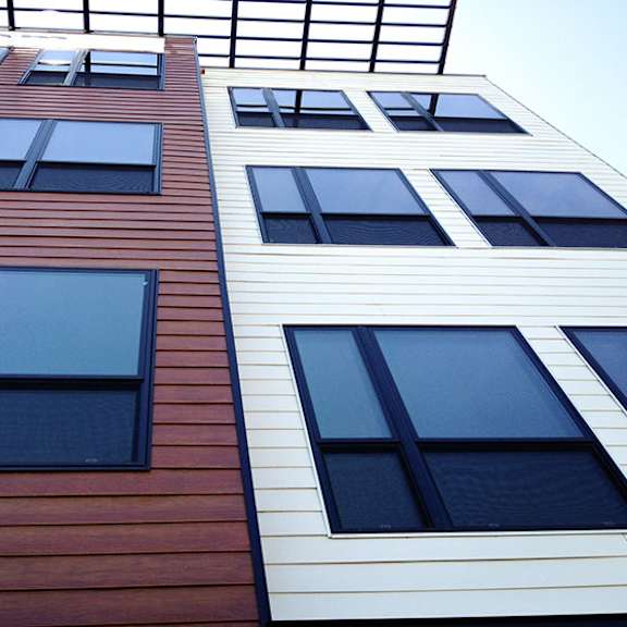 a building with a red and white facade and black windows.